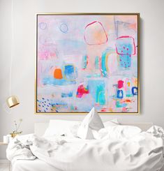 an abstract painting hangs above a bed with white sheets