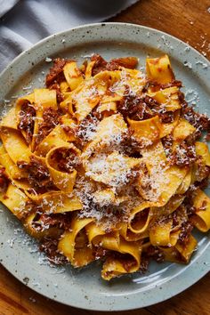 pasta with meat sauce and parmesan cheese on a plate