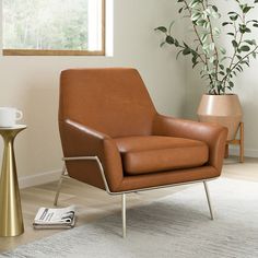 a brown leather chair sitting on top of a white rug