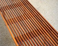 a wooden bench sitting on top of a cement floor