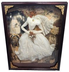 an old fashion doll is displayed in a shadow box