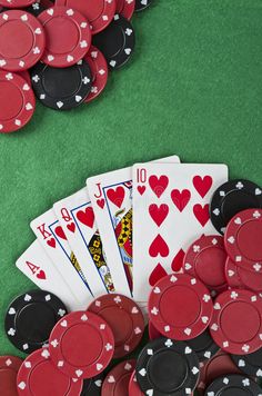 poker chips and playing cards on green felt