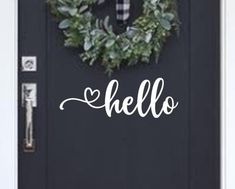 a door with a wreath and the word hello painted on it's front door