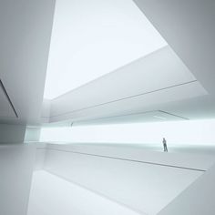 a man is standing in the middle of a room with white walls and flooring