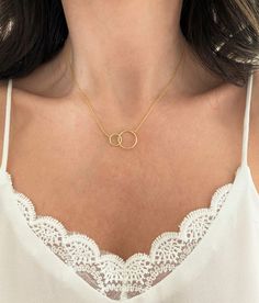 This is a lovely dainty Interlocking Circle Necklace. The chain is a 14K Gold Filled 1 mm cable style chain, which is made with a base metal of solid 925 Sterling Silver. Also, available in Sterling Silver and Rose Gold Filled in 16" and 18" Please take the time to check my whole Sterling Silver Necklace Collection in the following link: https://www.etsy.com/shop/PyPJewelry/edit?section_id=30258060 Silver Infinity Necklace, Double Circle Necklace, Classy Minimalist, Infinity Necklace Silver, Interlocking Circle Necklace, Interlocking Ring, Blue Opal Necklace, Karma Necklace, Mother Daughter Necklace