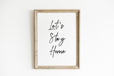 a black and white print with the words let's stay home