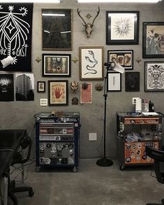 a room filled with lots of framed pictures and art on the wall next to a microphone