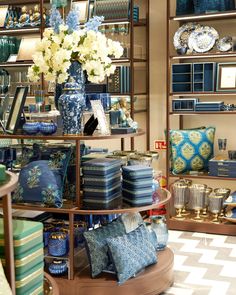 a store display with blue and white vases, pillows, and other decorative items