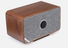 the speaker is made out of wood and grey fabric