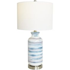 a blue and white striped lamp with a white shade on the top, sitting against a white background