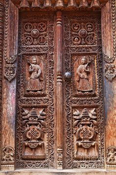 an ornate wooden door with carvings on it