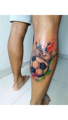 a man's leg with a tattoo on it and a soccer ball in the center