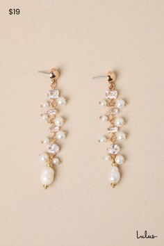 two pairs of earrings with pearls and crystals on the bottom one is gold, the other is white