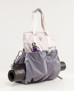 a white bag sitting on top of a table next to a black cup and camera