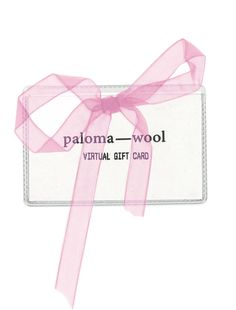 a pink ribbon tied around a white card with the words paloma wool on it