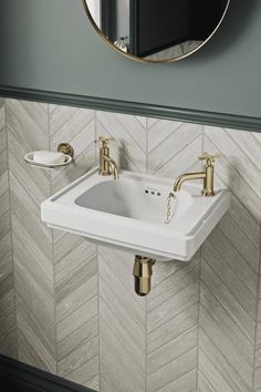 a white sink sitting under a mirror in a bathroom