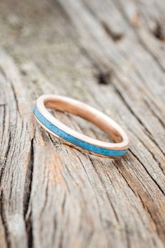 a close up of a wooden surface with a ring on it