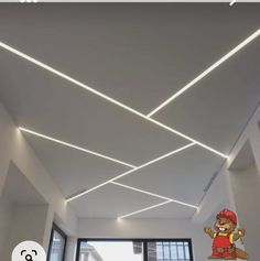 an image of a ceiling with lights in the middle and a teddy bear on the other side