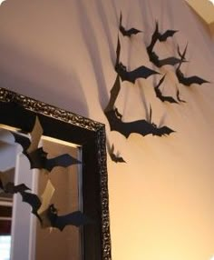 the bats are hanging on the wall above the mirror