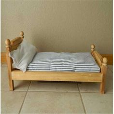 a small wooden bed sitting on top of a tiled floor