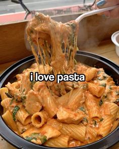 someone is eating some pasta with the words i love pasta