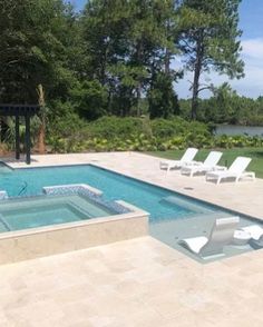 an empty swimming pool surrounded by lawn chairs