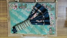 a blue and white bag sitting on top of a wooden floor