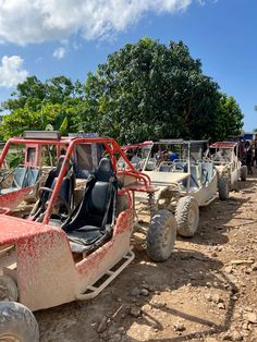 several off - road vehicles are parked on the dirt