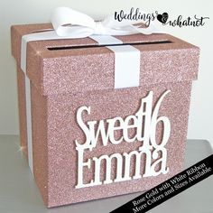 a pink gift box with the words sweet emma on it and a white bow