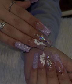 Lilac Baddie Nails, Lavender Baddie Nails, Latina Nail Designs Purple, Silver And Purple Acrylic Nails, Purple Prom Nails Coffin, Soft Makeup Look With Rhinestones, Short Acrylics With Rhinestones, Purple Bling Nails Rhinestones, Popular Acrylic Nails 2023