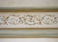 an ornate gold and white painting on the wall