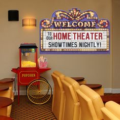 an old fashioned popcorn machine is in the corner of a room with chairs and tables