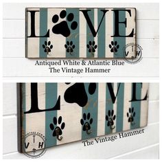 two wooden signs with dog paw prints on them, one is blue and the other is white