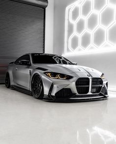 a silver sports car parked in front of a garage door