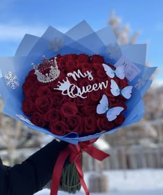 a woman holding a bouquet of red roses with the words my queen written on it