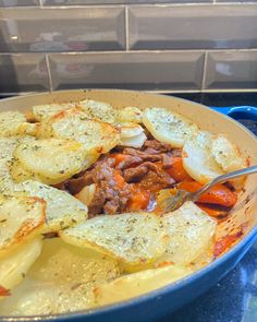 a blue pan filled with food on top of a stove