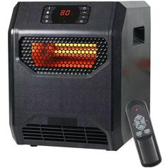 an electric heater sitting on top of a white table next to a remote control