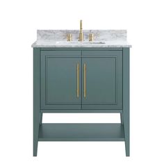 a bathroom vanity with marble top and two gold faucets