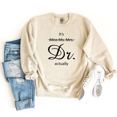 Miss Ms. Mrs. It's Dr Actually Sweatshirt is awesome gift idea for future doctor, medical student, or PHD Graduation!                                                                         ⭐  HOW TO ORDER   ⭐  1-) Please check all the photos from the listing. 2-) Please choose your sweatshirt size and color. (Sweat sizes are shown on the listing photos) 3-) Please choose your quantity. 4-) Add to cart 5-) Then please click Proceed to checkout. You are all set !                                                                                          ⭐  FABRICATION  ⭐  ⭐️ 50% cotton, 50% polyester ⭐️ Medium-heavy fabric (8.0 oz/yd² (271.25 g/m ⭐️ Double-needle stitching at shoulder, armhole, neck, waistband, and cuffs ⭐️ 1x1 rib with spandex ⭐️ Air jet yarn for a softer feel and reduced pil Gifts For Doctorate Graduation, Doctoral Graduation Outfit, Phd Student Outfit, Dnp Nursing, Med School Graduation Party, Doctorate Graduation Party, Doctorate Graduation Pictures, Future Doctor Gifts, Doctorate Graduation