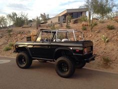 a black jeep parked on the side of a road