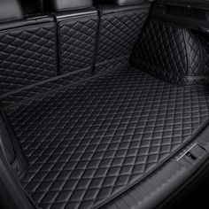 the trunk area of a car with all black leather and diamond quilting on it