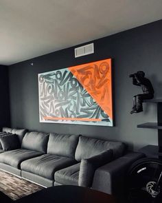 a living room filled with furniture and a painting on the wall