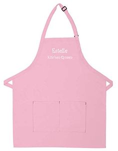 a pink apron with the words esttelle kitchen creations on it's front