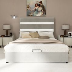 a bed with an angel painting on the wall above it and two nightstands next to it