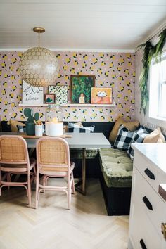 a living room filled with furniture next to a kitchen and dining room table in front of a window