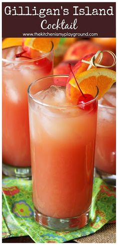 two glasses filled with orange juice and garnished with cherries on the rim