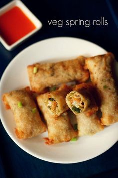 vegetable spring rolls on a plate with dipping sauce