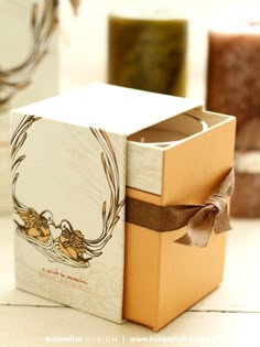 a box with a ribbon tied around it sitting on a table