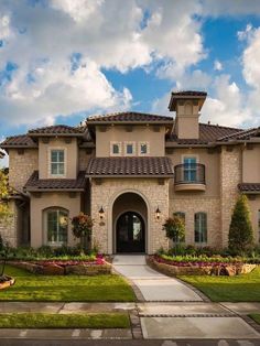 a large house with lots of windows and landscaping