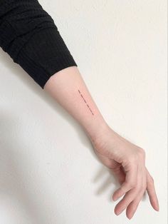 a person's arm with a small tattoo on it, and the word love is written